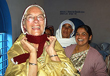 A smiling Vanya Orr dressed in traditional garments with some of the village women Vanya Orr